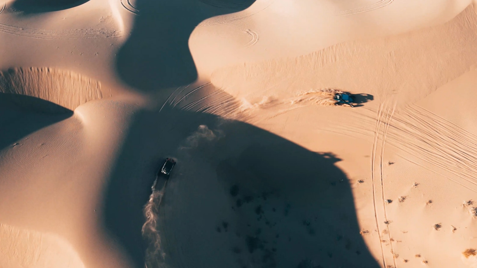 drone footage of ATVs riding in sand dunes